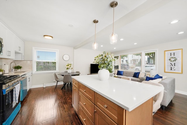 kitchen with decorative backsplash, dark hardwood / wood-style flooring, stainless steel appliances, decorative light fixtures, and sink