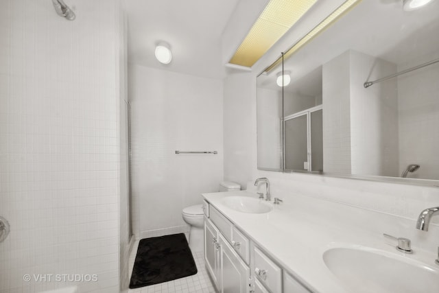 bathroom with vanity, tile patterned flooring, a shower with shower door, and toilet