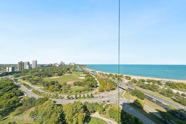 drone / aerial view featuring a beach view and a water view