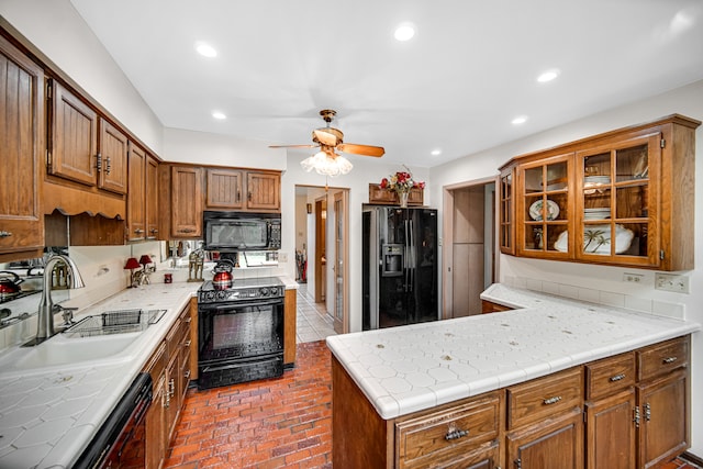 kitchen featuring sink, black appliances, and ceiling fan