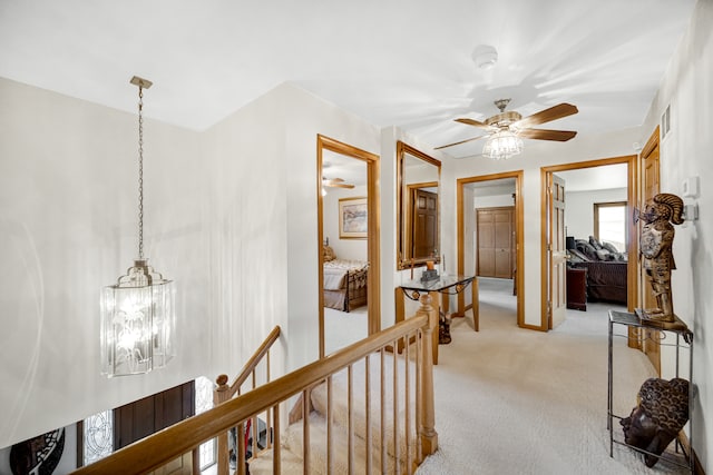 hall with light colored carpet