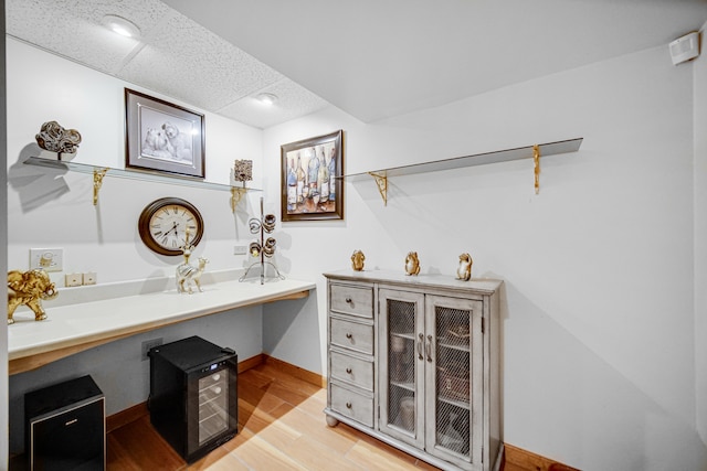 office with a paneled ceiling and light hardwood / wood-style floors