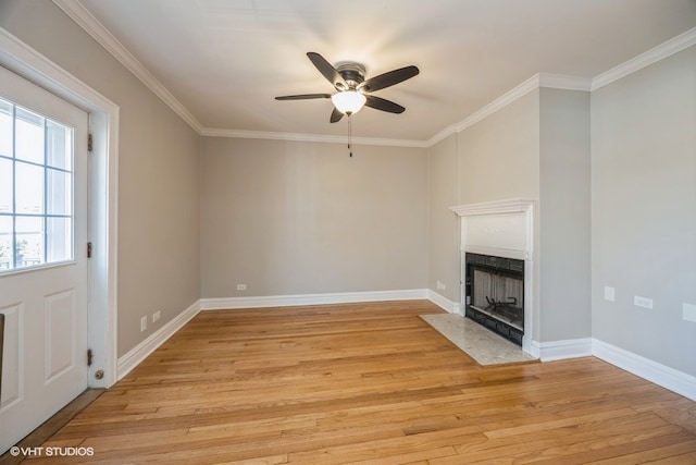 unfurnished living room featuring ceiling fan, light hardwood / wood-style flooring, and ornamental molding