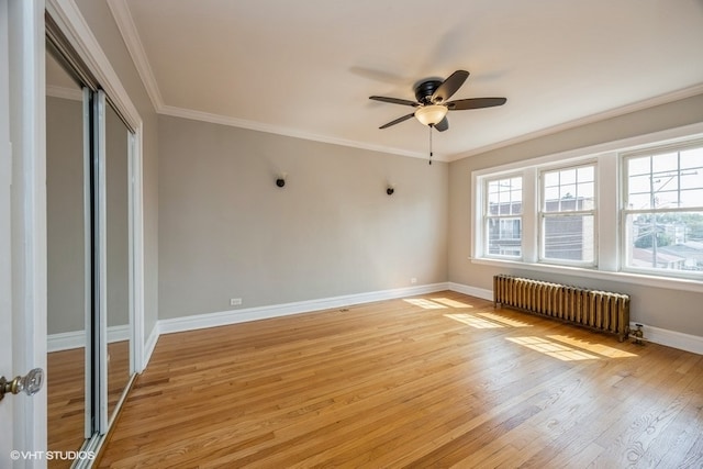 unfurnished bedroom featuring crown molding, light hardwood / wood-style floors, radiator, and ceiling fan