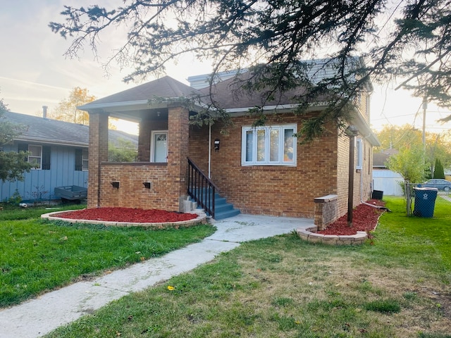 bungalow-style home featuring a front yard