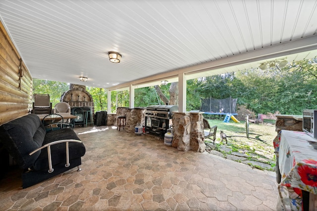 view of patio / terrace featuring a trampoline, area for grilling, and a grill