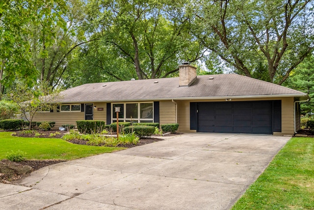 single story home featuring a front yard and a garage