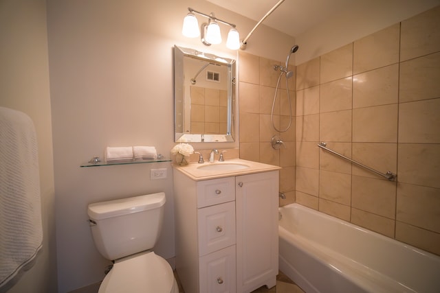 full bathroom with tiled shower / bath, vanity, and toilet