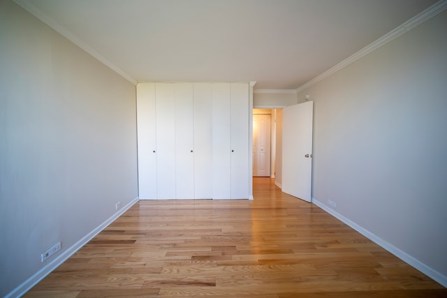 unfurnished bedroom with light wood-type flooring and ornamental molding