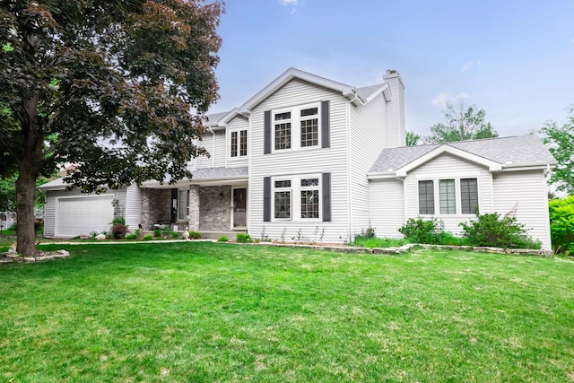 view of front of house featuring a front yard and a garage