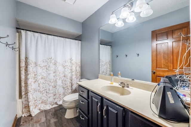 full bathroom featuring shower / bath combination with curtain, vanity, toilet, and hardwood / wood-style flooring