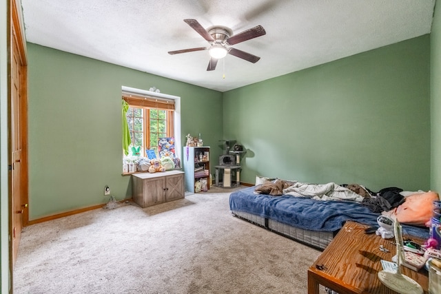 carpeted bedroom with ceiling fan and a textured ceiling