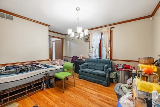 living room with a chandelier, hardwood / wood-style floors, and crown molding