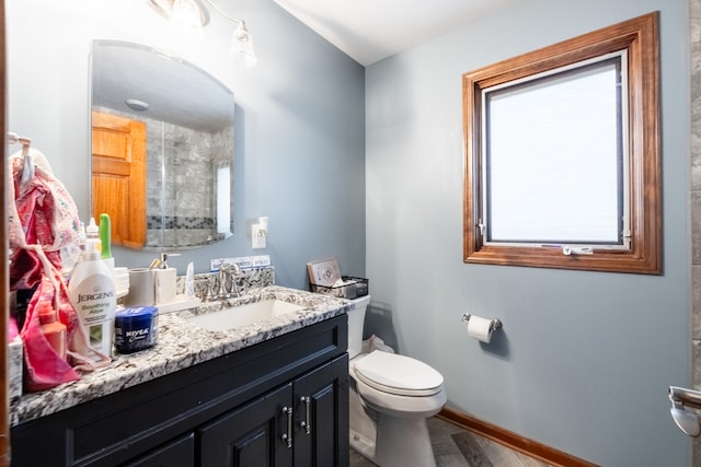 bathroom featuring hardwood / wood-style floors, vanity, and toilet