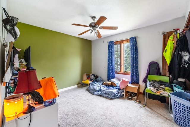 recreation room with ceiling fan and carpet