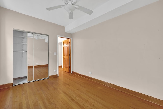 unfurnished bedroom with light hardwood / wood-style flooring, a closet, and ceiling fan