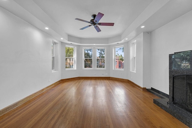 unfurnished living room with ceiling fan and hardwood / wood-style floors