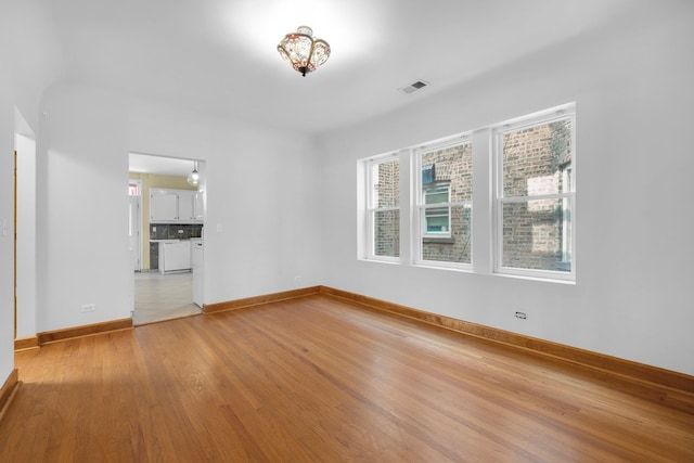 unfurnished room with light hardwood / wood-style flooring