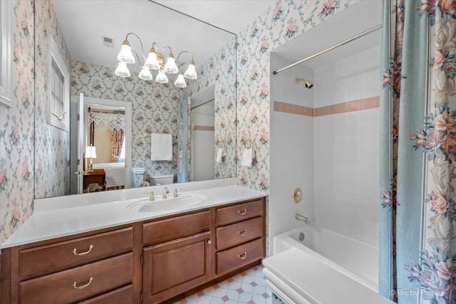 full bathroom with vanity, toilet, and tiled shower / bath combo