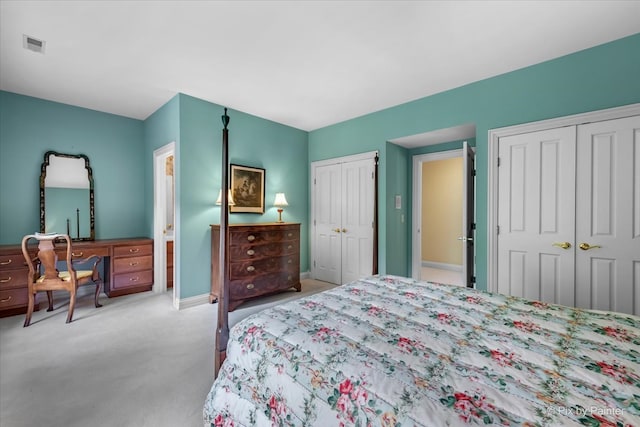 carpeted bedroom featuring two closets