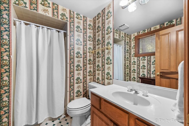 bathroom featuring vanity, toilet, and a shower with shower curtain