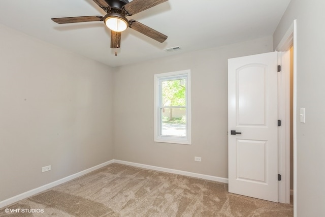 unfurnished room featuring ceiling fan and light carpet