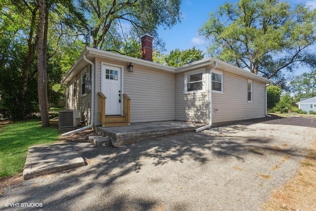 view of front of house featuring a patio and central AC