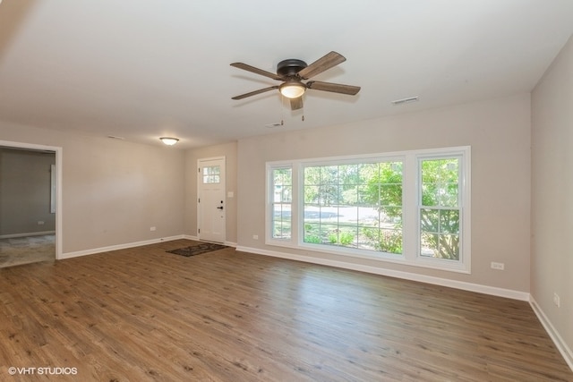 unfurnished room featuring ceiling fan and dark hardwood / wood-style flooring