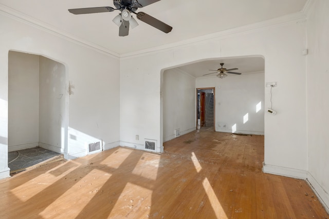 spare room with ornamental molding, ceiling fan, and hardwood / wood-style flooring