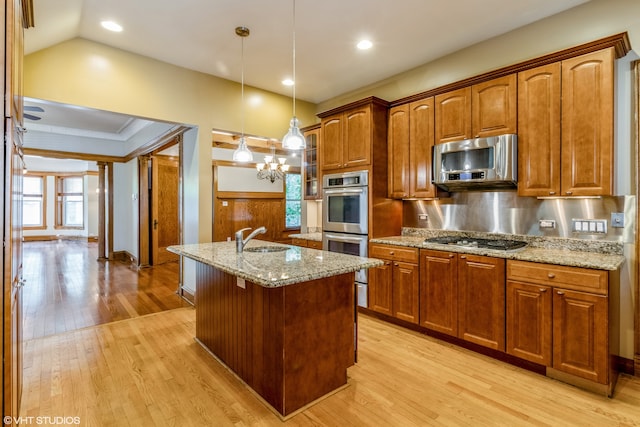 kitchen featuring hanging light fixtures, light hardwood / wood-style flooring, backsplash, and a notable chandelier