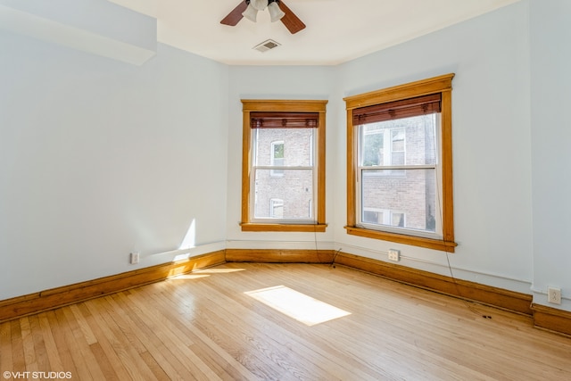 empty room with light hardwood / wood-style floors and ceiling fan