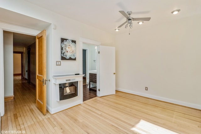 empty room featuring wood-type flooring and ceiling fan