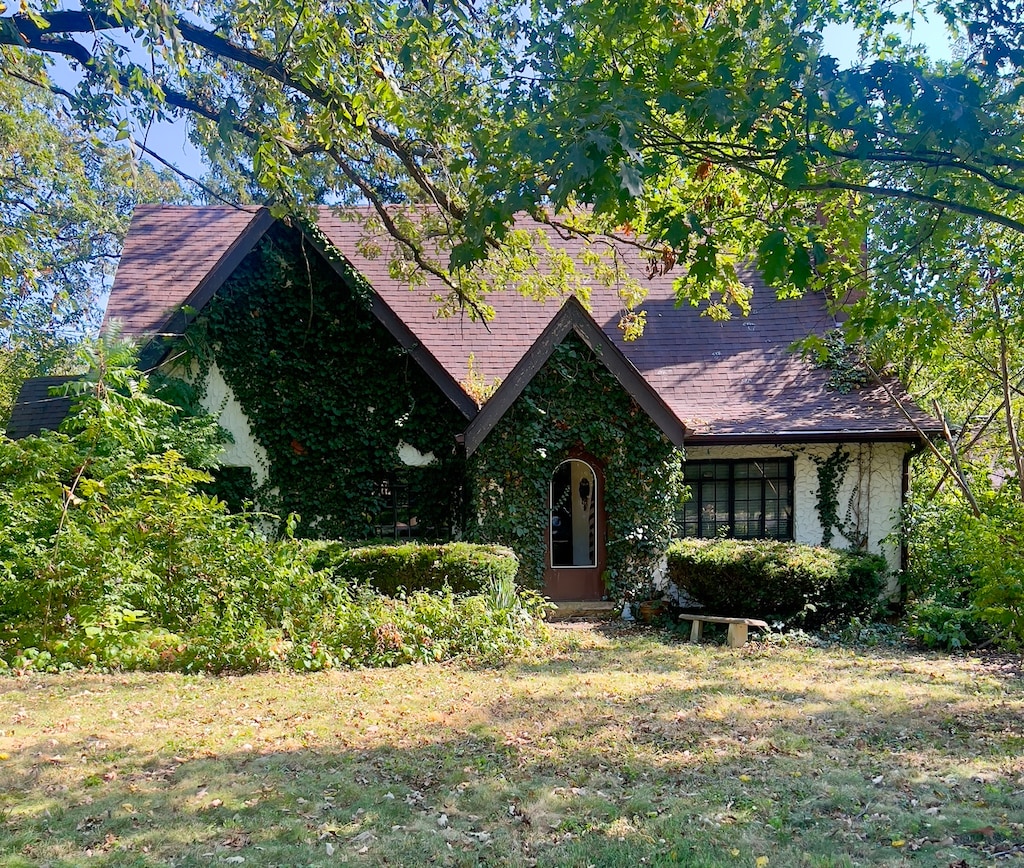 english style home with a front yard