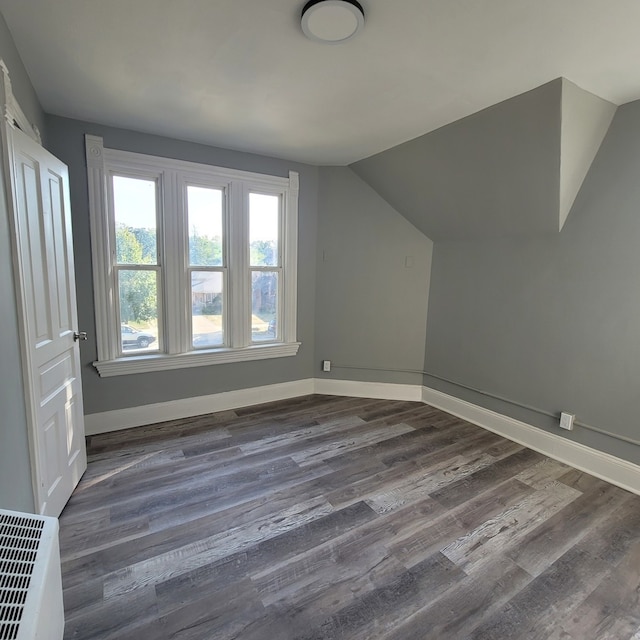 additional living space with lofted ceiling and dark wood-type flooring