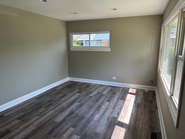 spare room featuring dark wood-type flooring