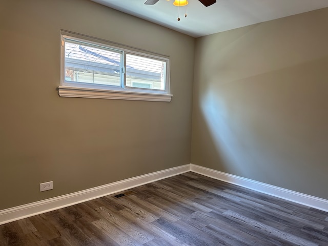 empty room featuring ceiling fan and dark hardwood / wood-style flooring