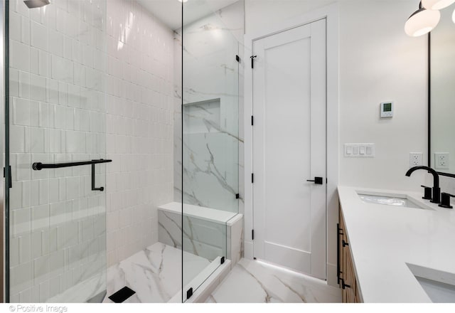 bathroom featuring vanity and a shower with door