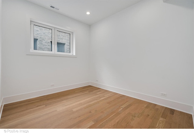 empty room with light hardwood / wood-style flooring