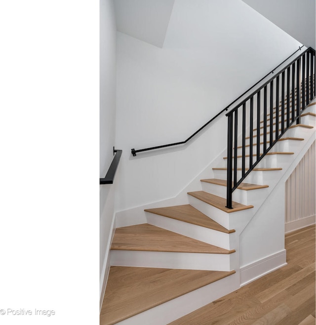 stairway with hardwood / wood-style flooring