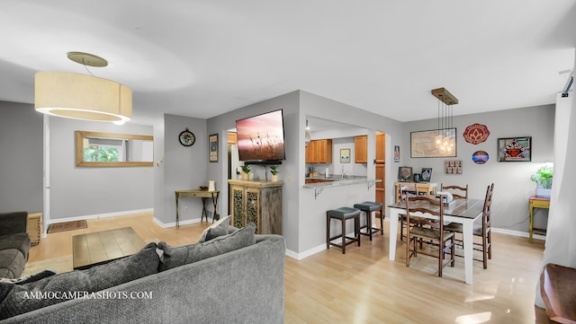 living room with sink and light hardwood / wood-style flooring