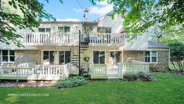 back of property featuring a wooden deck and a lawn