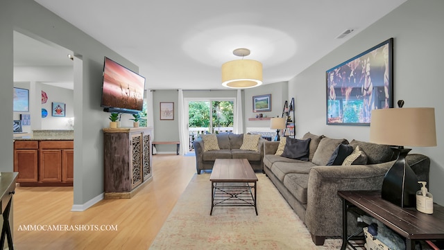 living room with light hardwood / wood-style flooring