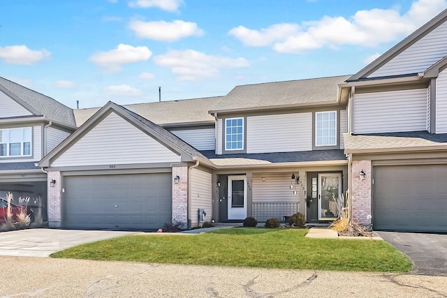 view of property with driveway, brick siding, a shingled roof, and a front yard