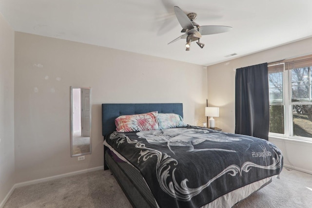 carpeted bedroom with ceiling fan, visible vents, and baseboards