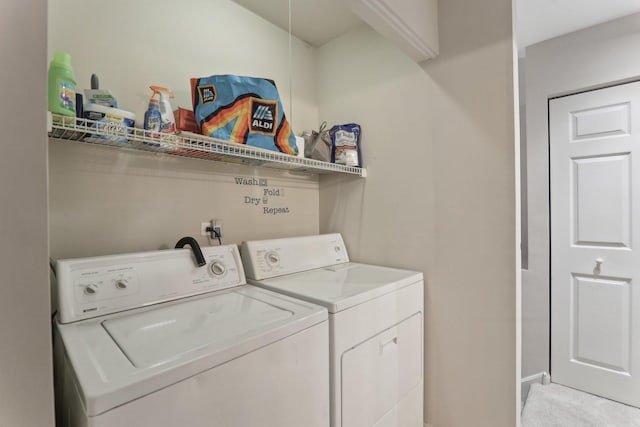 laundry area with laundry area, light colored carpet, and washer and clothes dryer