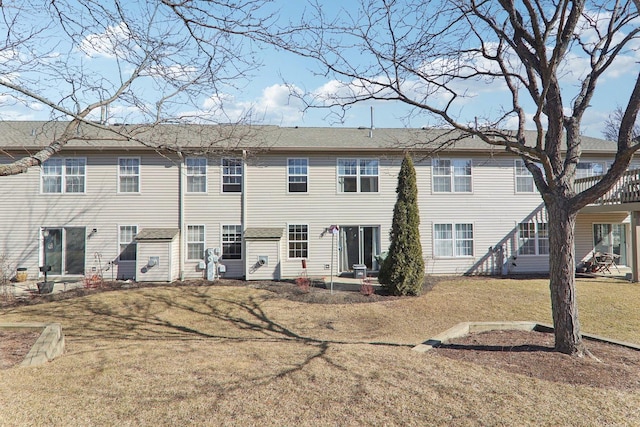 rear view of property with a lawn