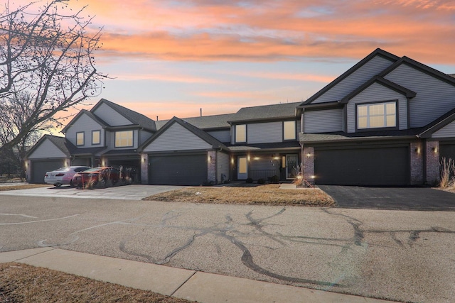 view of front of home with aphalt driveway and brick siding