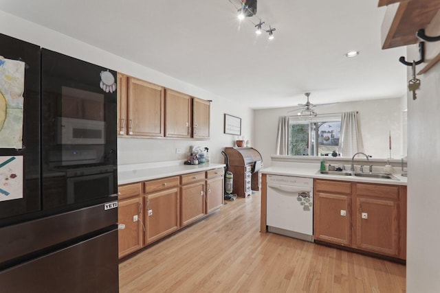 kitchen featuring light countertops, light wood-style flooring, brown cabinetry, a sink, and white appliances