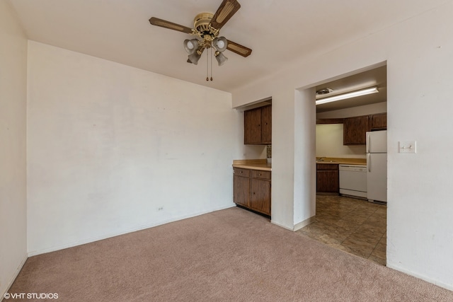 interior space featuring light carpet and ceiling fan