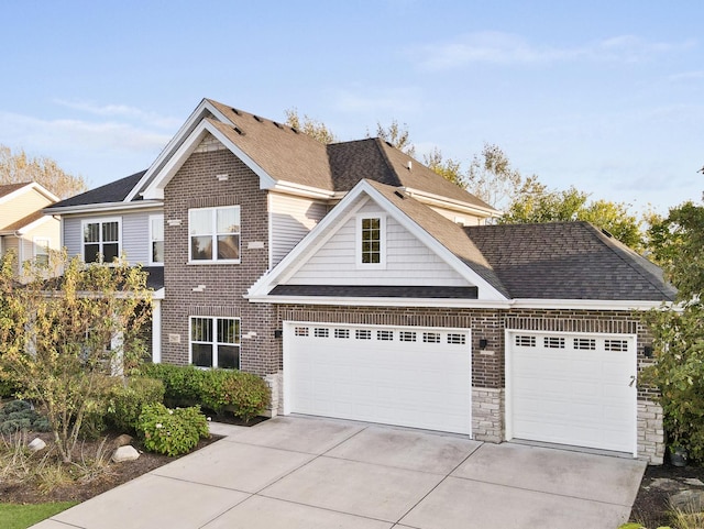 view of front facade featuring roof with shingles, concrete driveway, stone siding, brick siding, and a garage